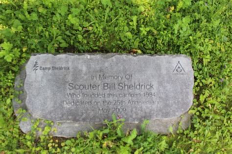 A photo displaying an engraved stone, dedicating the camp to founder Scouter Bill Sheldrick